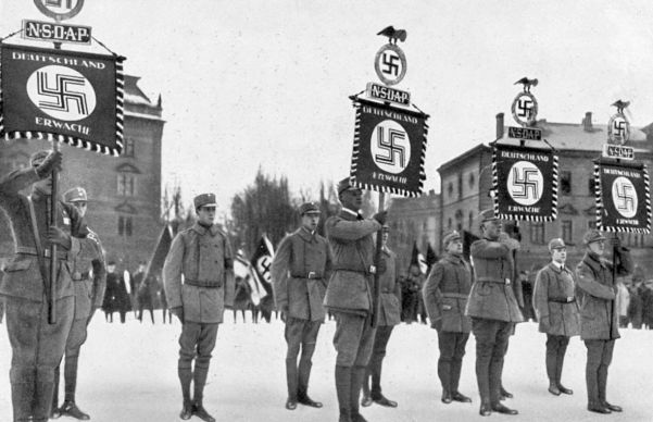 SA men carry Deutschland Erwache (Germany Awake) standards at the 1st Nazi Party Day, January 1928.