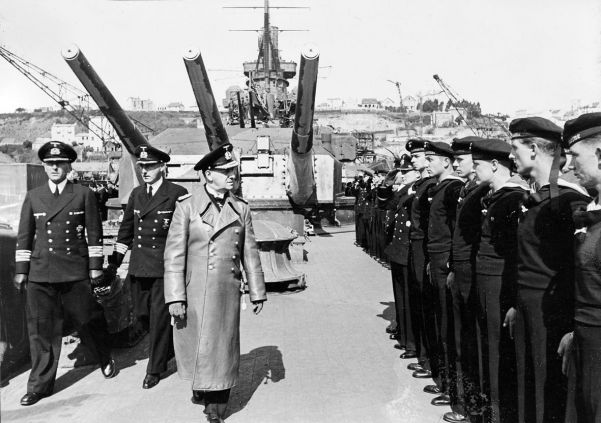 Erich Raeder inspects men of his newly titled Kriegsmarine. The building of surface ships and submarines was increased in 1935.