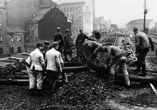 For German workers in 1944 laying new railroad tracks after Allied air raids, in this case after an US 8th Air Force attack