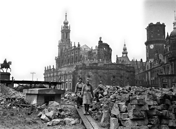Women help clear rubble from the ruins of the Catholic cathedral in Dresden